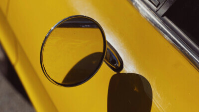 rearview mirror on a yellow car