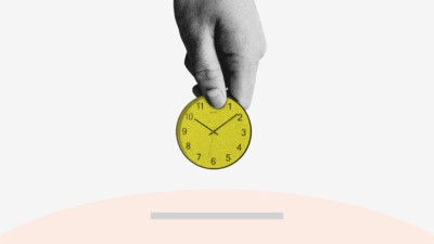 Poor time management image hand holding a clock, placing it into the slot of a piggy bank